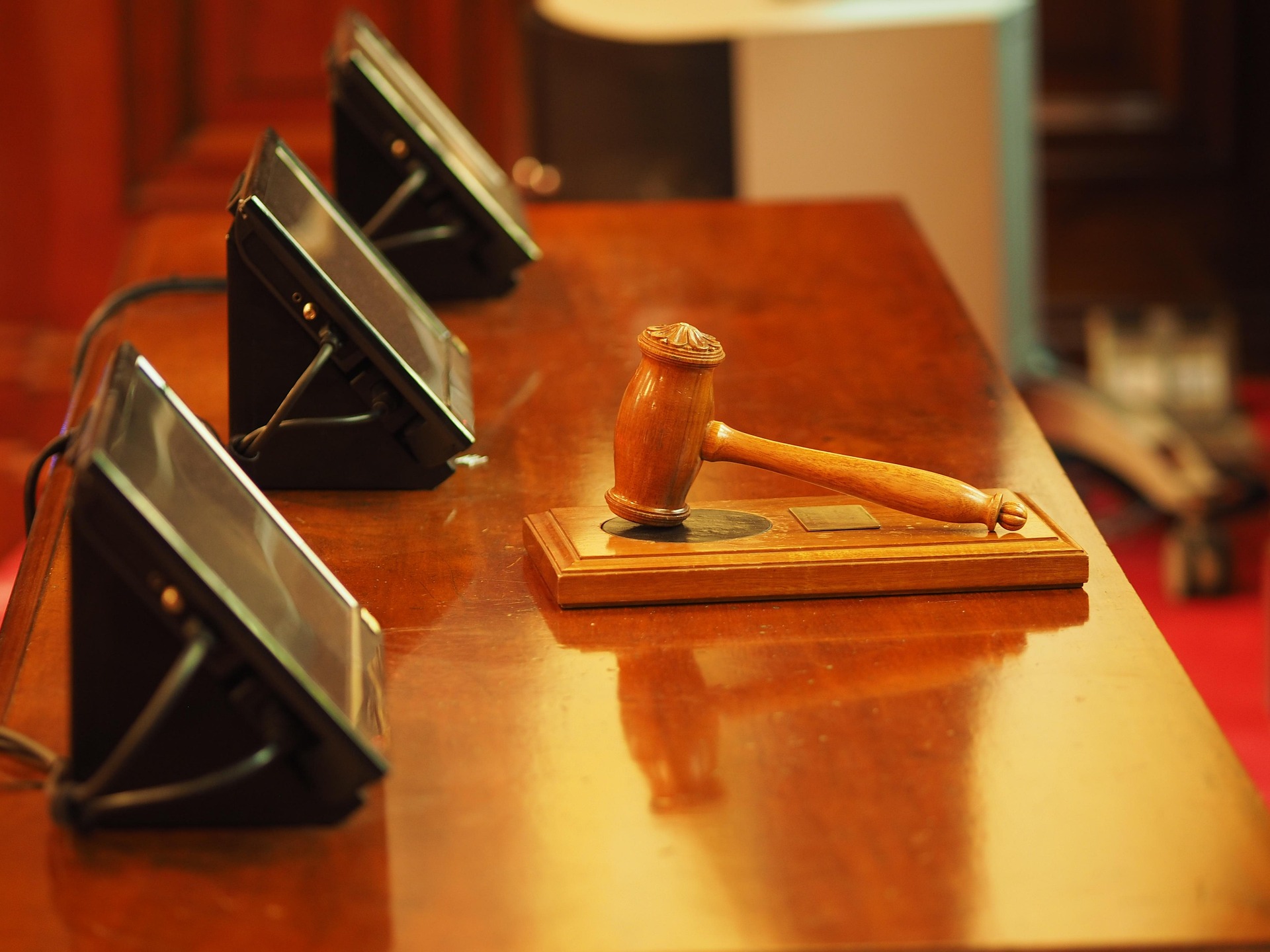 Judge's gavel resting on the bench in a courtroom, symbolizing judicial authority and legal proceedings.