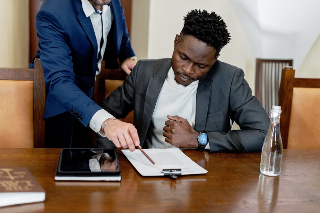 Attorney explaining legal documents to a client during a consultation before signing important paperwork.